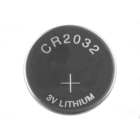 CR2032 battery powering an AirTag and remote in a European workspace